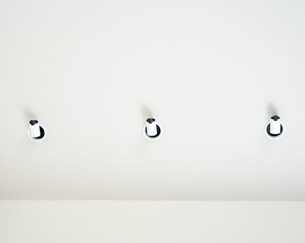 Three ceiling-mounted spotlights aligned
